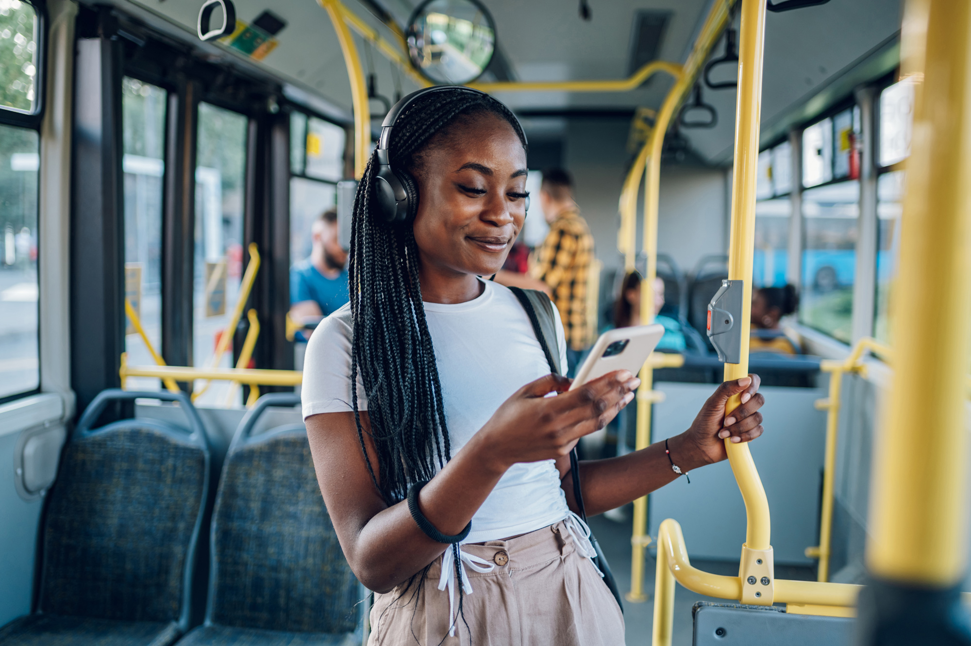 A woman riding the bus and on her phone 