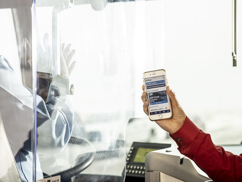 Person with smartphone on bus