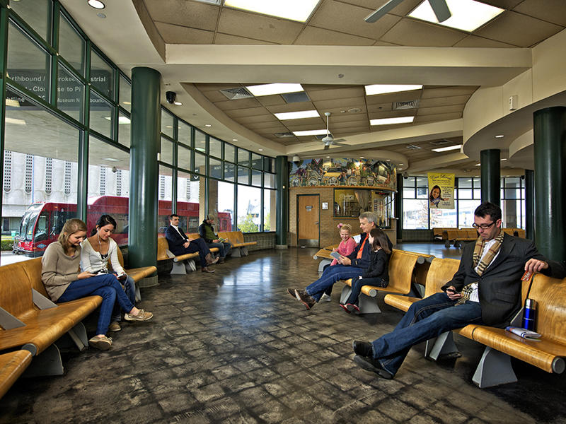 People waiting at indoor bus station