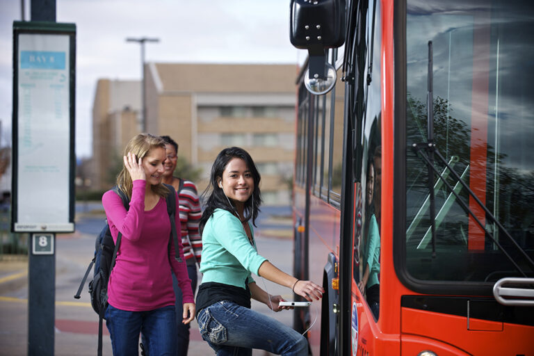 Two girls boarding the bus